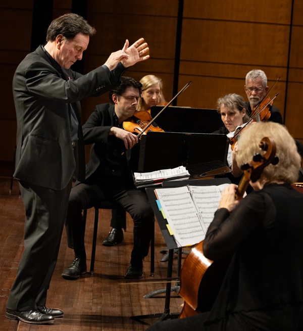 Photo of Ryan Brown conducting the Opera Lafayette Orchestra